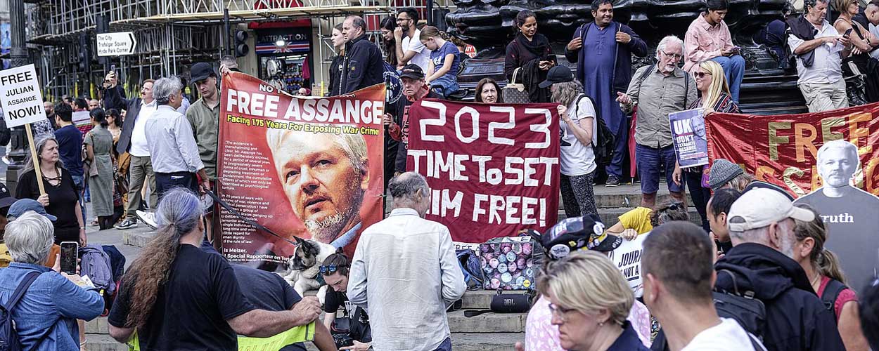 Activists supporting Julian Assange in London's Piccadilly Circus with banners declaring 'Free Assange' and '2023 - Time to Set Him Free!'